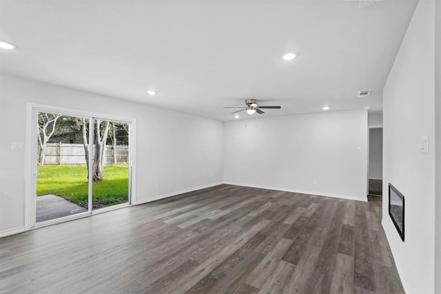 unfurnished room featuring dark hardwood / wood-style floors and ceiling fan