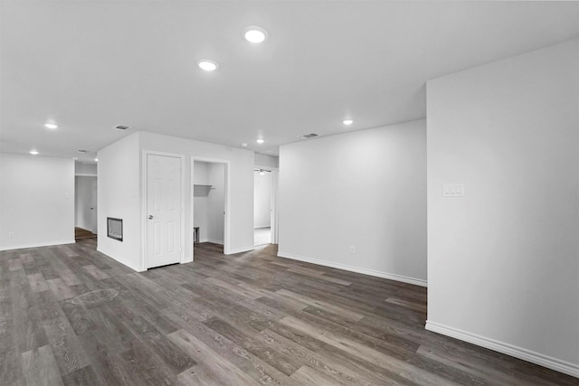 unfurnished living room with dark hardwood / wood-style flooring