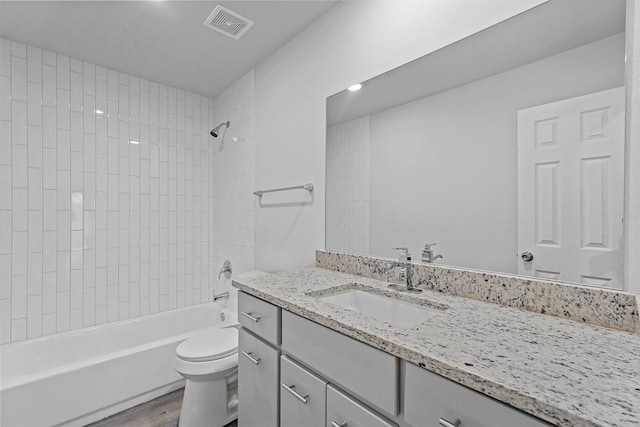 full bathroom with wood-type flooring, vanity, toilet, and tiled shower / bath