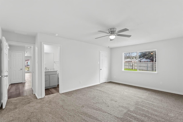 unfurnished room featuring ceiling fan and dark colored carpet