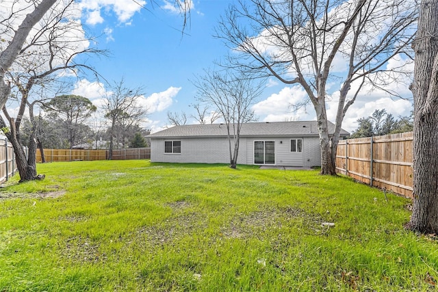 rear view of property featuring a yard