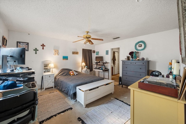 bedroom with ceiling fan and a textured ceiling