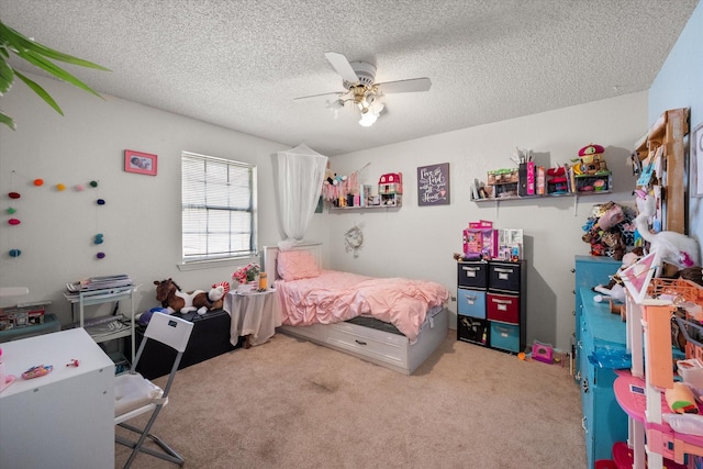 carpeted bedroom with ceiling fan and a textured ceiling