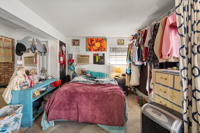 bedroom with cooling unit and a textured ceiling