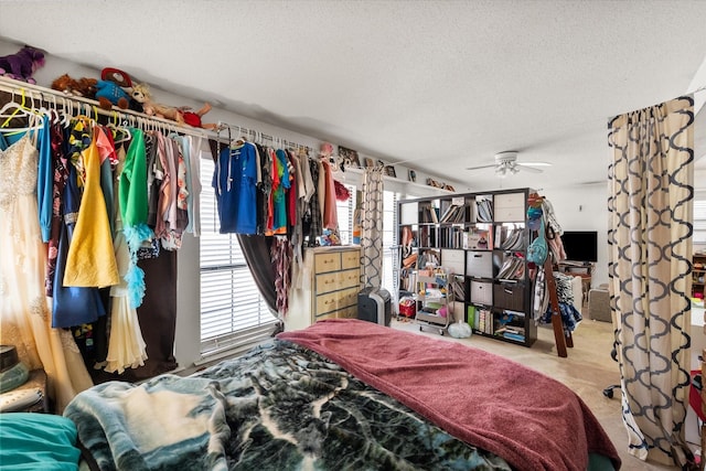 bedroom with ceiling fan and a textured ceiling