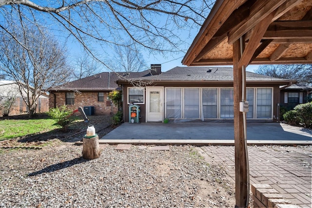 view of front of property featuring cooling unit and a patio area