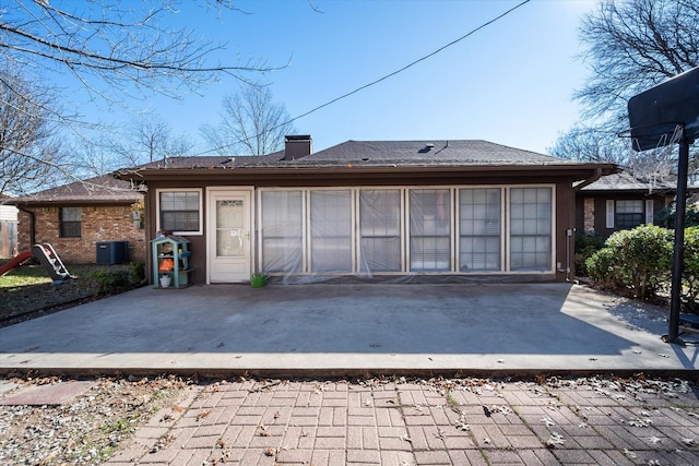 rear view of property featuring central AC and a patio