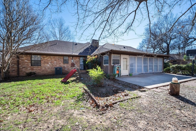 view of side of home with a yard, central AC, and a patio area