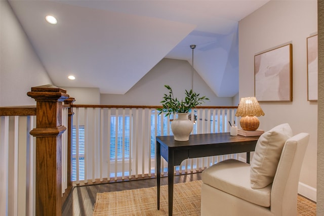 office area featuring hardwood / wood-style flooring, a water view, and vaulted ceiling