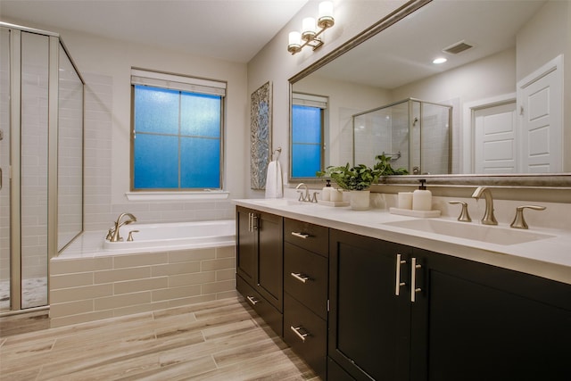 bathroom with vanity and separate shower and tub