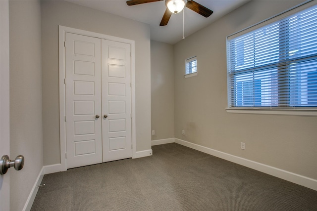 unfurnished bedroom with carpet flooring, ceiling fan, and a closet