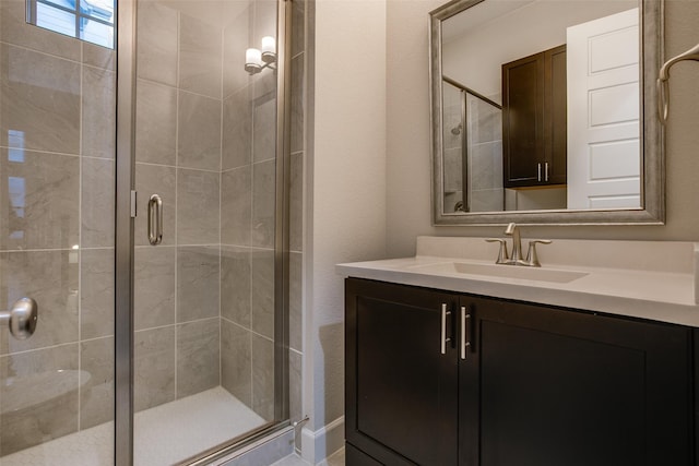 bathroom featuring vanity and an enclosed shower