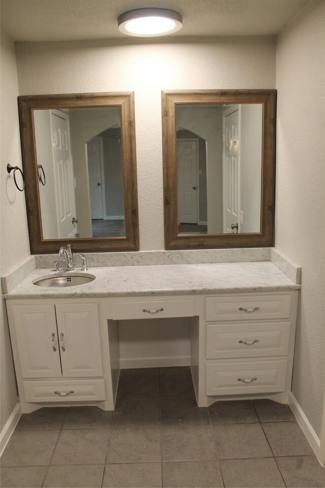 bathroom with tile patterned flooring and vanity