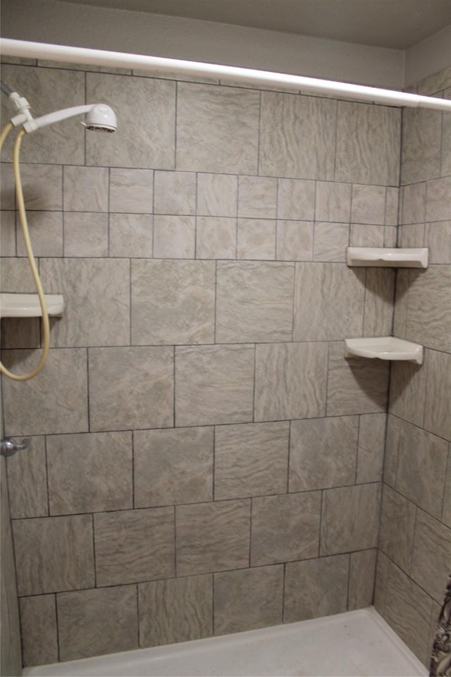 bathroom with a tile shower