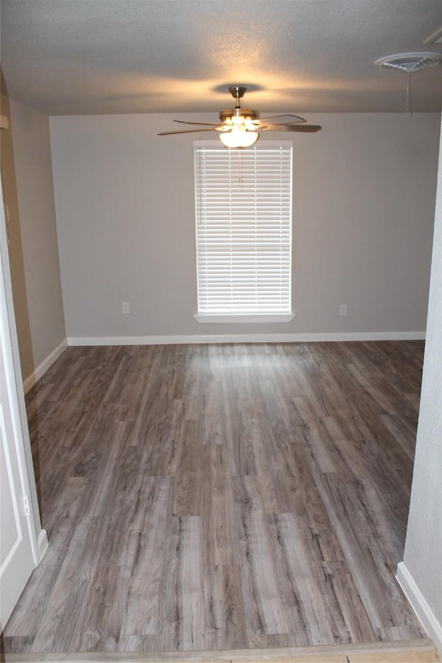 spare room featuring hardwood / wood-style floors and a textured ceiling