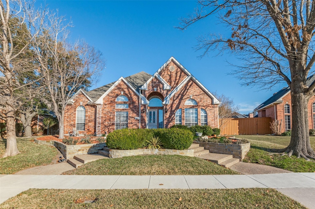 view of property featuring a front lawn