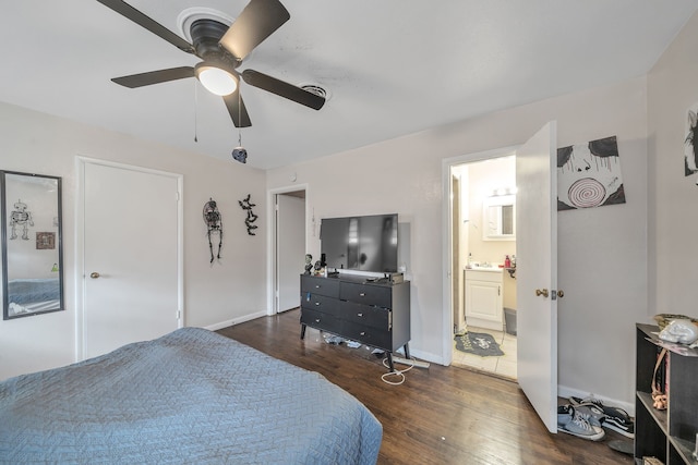 bedroom with ensuite bath, ceiling fan, and dark wood-type flooring