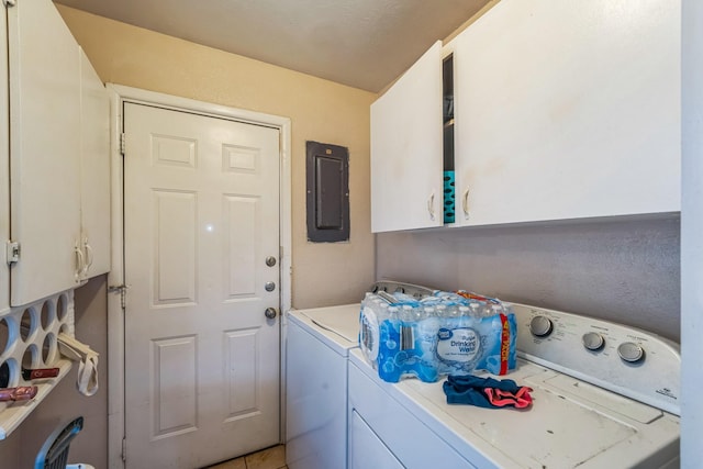 laundry room featuring cabinets, light tile patterned floors, washing machine and dryer, and electric panel