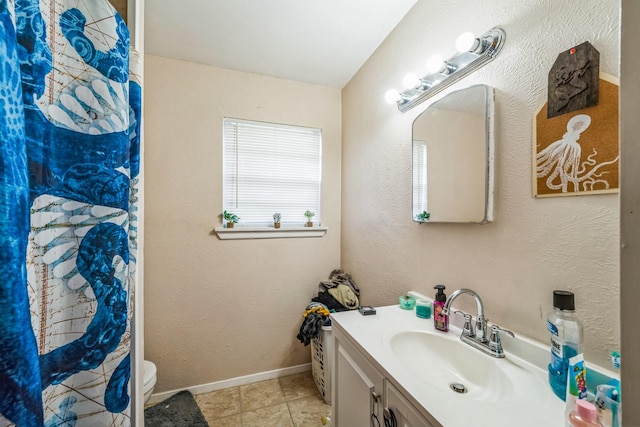 bathroom with tile patterned floors, vanity, toilet, and curtained shower