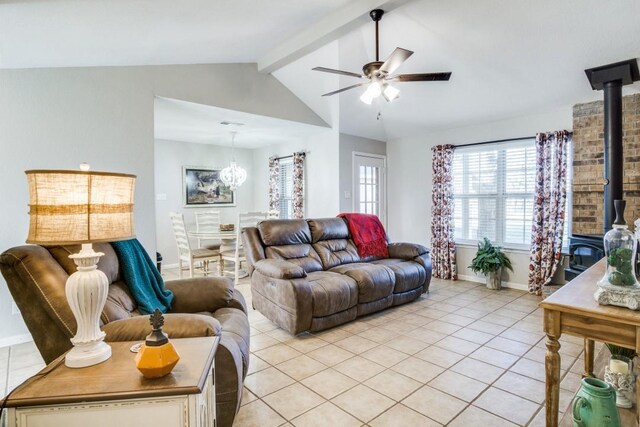 tiled living room with ceiling fan with notable chandelier, vaulted ceiling with beams, and a wood stove