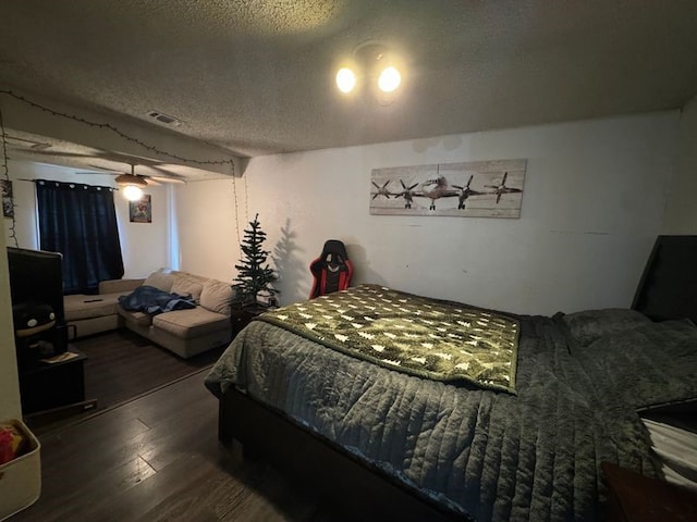 bedroom with hardwood / wood-style floors and a textured ceiling