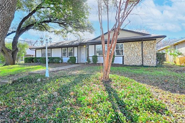 ranch-style home featuring a front yard