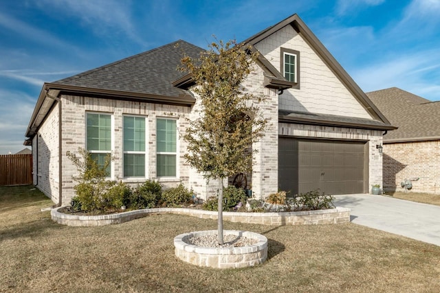 view of front of home featuring a garage and a front lawn