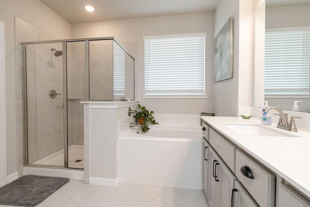 bathroom with tile patterned flooring, vanity, and shower with separate bathtub