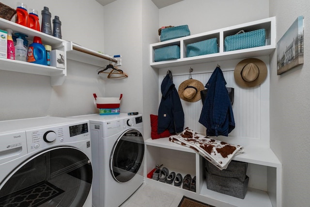 laundry area featuring washer and clothes dryer and tile patterned floors