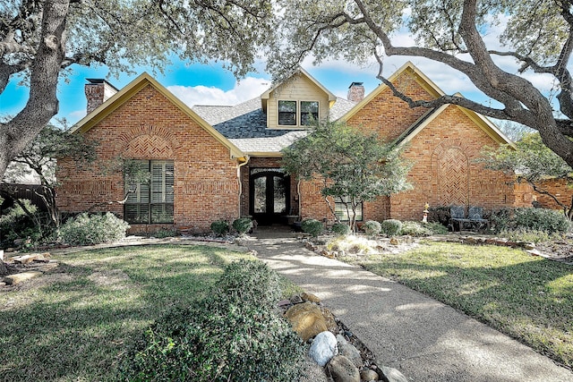 view of front facade featuring a front lawn and french doors