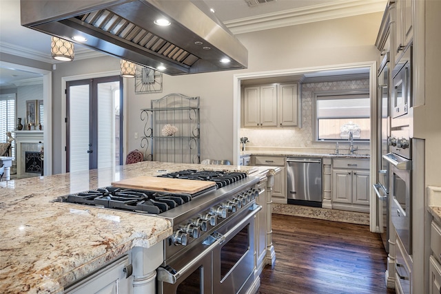 kitchen featuring island exhaust hood, light stone countertops, stainless steel appliances, dark wood-type flooring, and crown molding