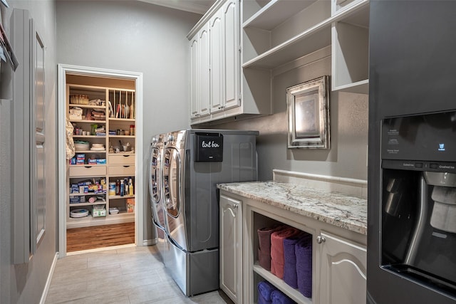 laundry area featuring cabinets and separate washer and dryer