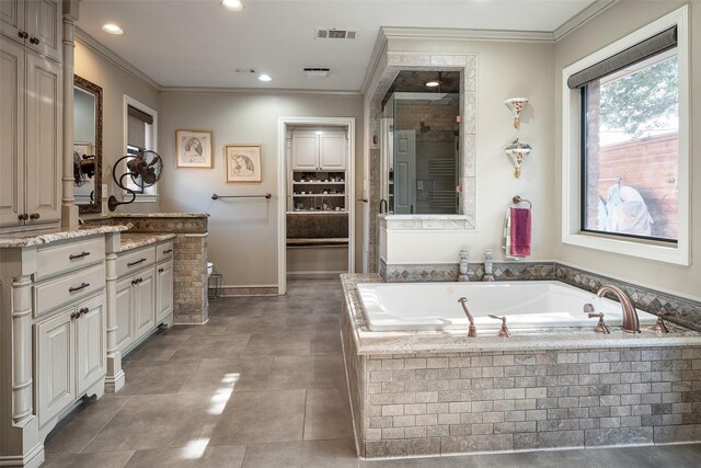 bathroom featuring vanity, shower with separate bathtub, and ornamental molding