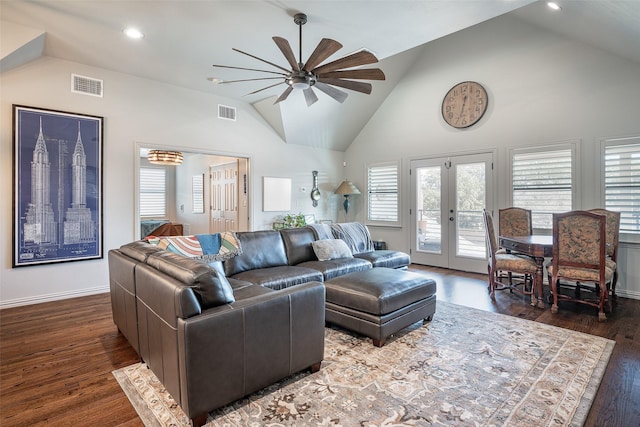 living room with ceiling fan, vaulted ceiling, dark hardwood / wood-style flooring, and french doors