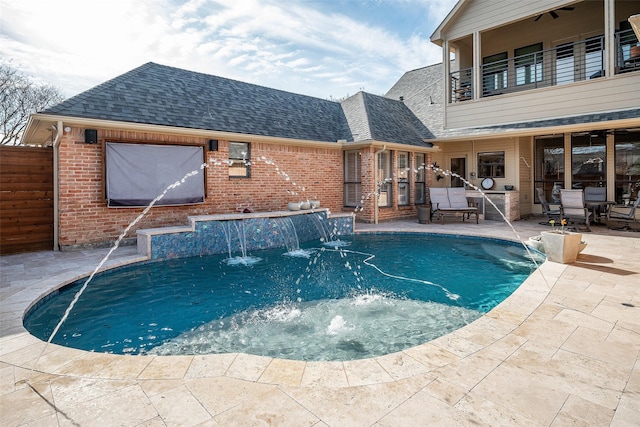 view of pool featuring pool water feature and a patio area