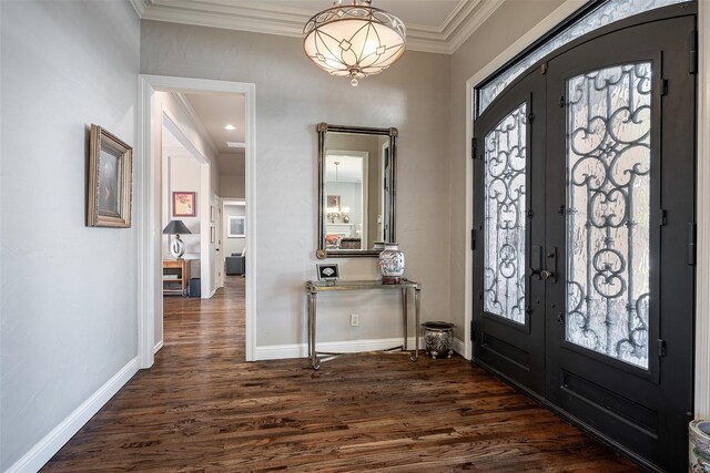 entrance foyer featuring dark hardwood / wood-style flooring, french doors, and ornamental molding