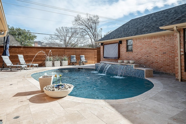 view of swimming pool featuring pool water feature and a patio