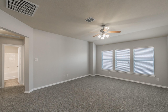 unfurnished room featuring ceiling fan and dark colored carpet