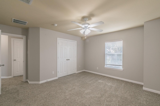 unfurnished bedroom with ceiling fan, carpet floors, and a closet