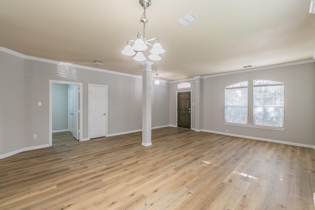 interior space with ornate columns, ornamental molding, and light hardwood / wood-style floors