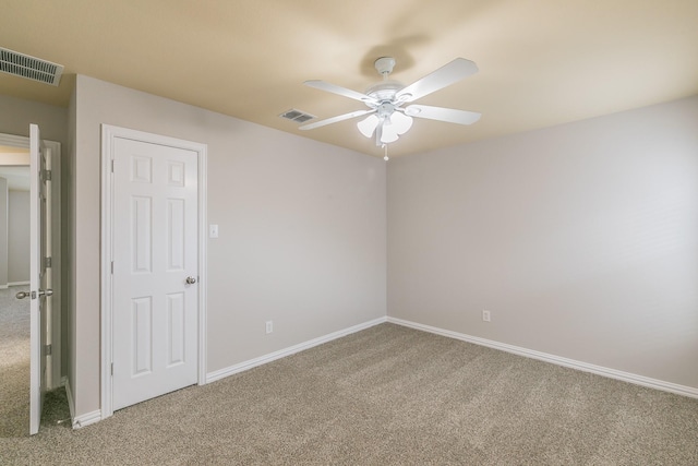 carpeted empty room featuring ceiling fan