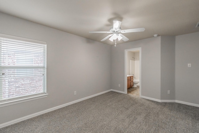 carpeted spare room with ceiling fan