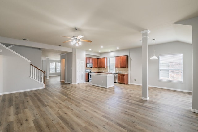 unfurnished living room featuring lofted ceiling, light hardwood / wood-style flooring, and ceiling fan