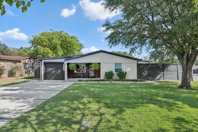 view of front facade featuring covered porch, a garage, and a front lawn