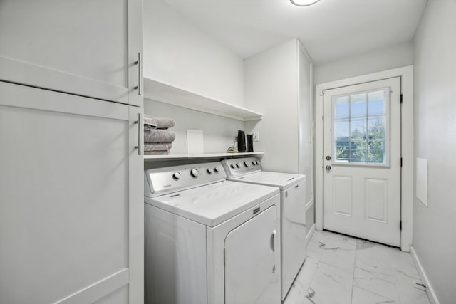 clothes washing area featuring washing machine and clothes dryer