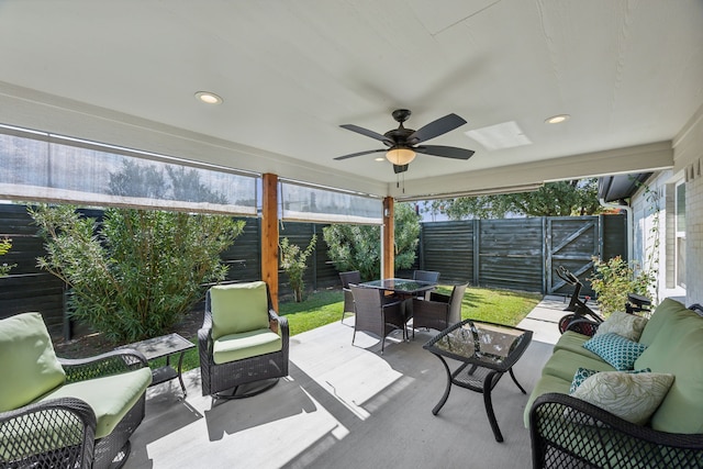 sunroom featuring ceiling fan