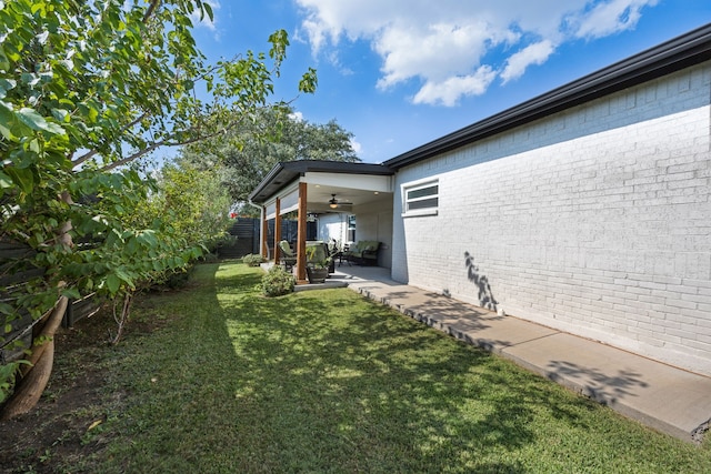 view of yard with ceiling fan