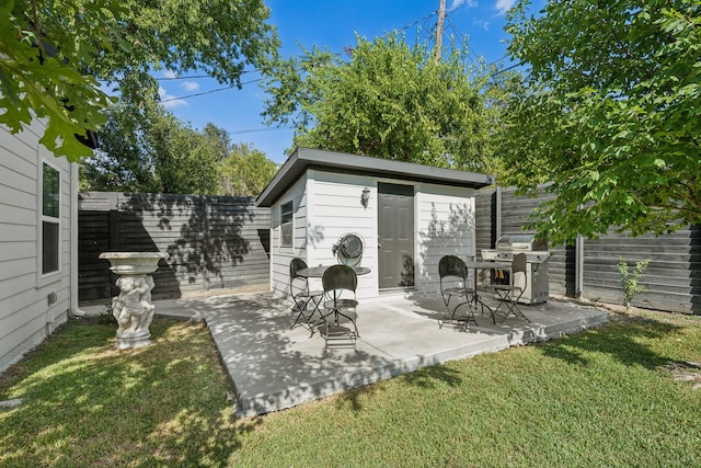 view of patio featuring a grill and a storage unit