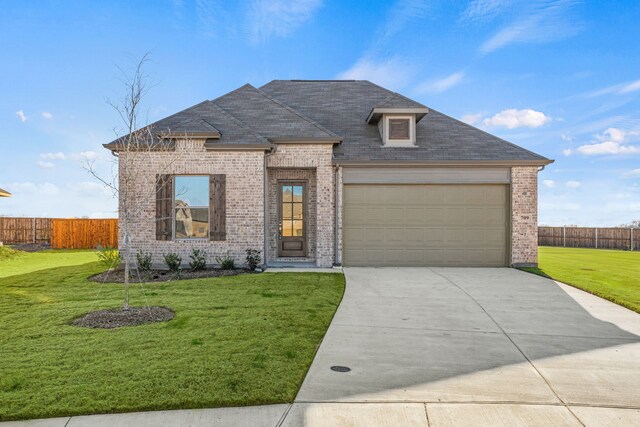 view of front of house with a garage and a front lawn