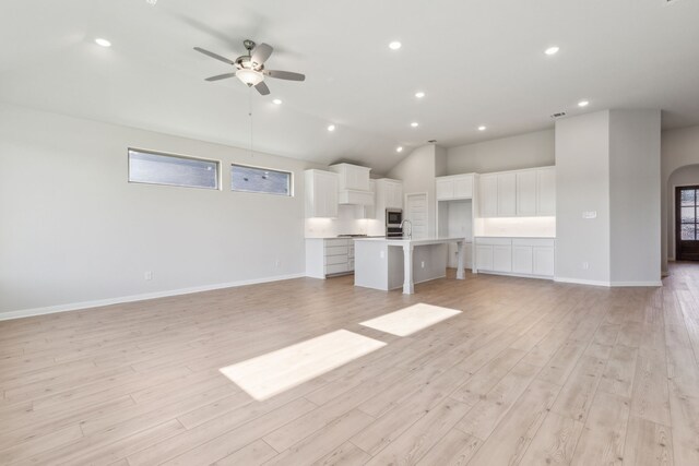 unfurnished living room featuring light wood-type flooring and ceiling fan